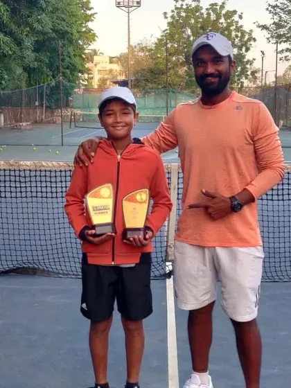 A coach celebrating the double crown victory with Aarav Chhallani in Gurugram.