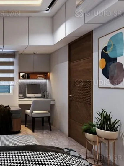 A compact and functional study nook is cleverly integrated into the bedroom design, complete with a desk, comfortable chair, and overhead storage.