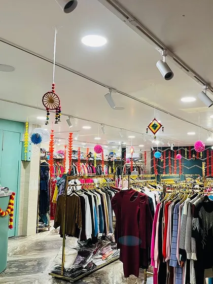 An example of our non-balloon festive decor for a retail space. For this Diwali setup at a clothing store, we used traditional elements like marigold garlands on the counter and colorful hanging decor to create a warm, inviting, and festive shopping atmosphere.