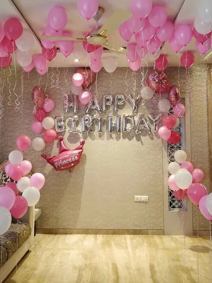 Here is a sweet and simple birthday decoration I did for a princess-themed party at home. The room is filled with pink and white balloons, a large 'Happy Birthday' foil banner, and a special 'Princess' crown balloon to make the birthday girl feel cherished.