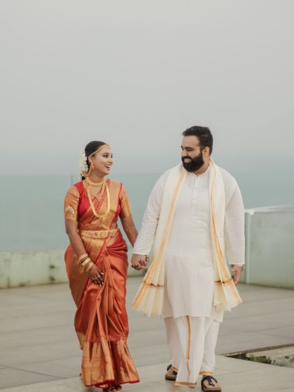 A Tale of Two Cultures: Manisha (Telugu) and Ishan (Bengali) in a classic portrait, their coordinated outfits reflecting a beautiful blend of traditions.