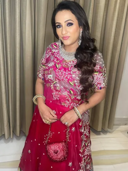 Confidence and glamour combined. Her radiant smile shows she feels as good as she looks, ready for a night of celebration.
