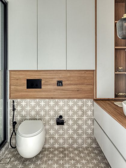 We used floating elements, like the wall-mounted toilet, to make the compact bathroom feel more expansive. Vertical storage and a light color palette also contribute to the sense of space.