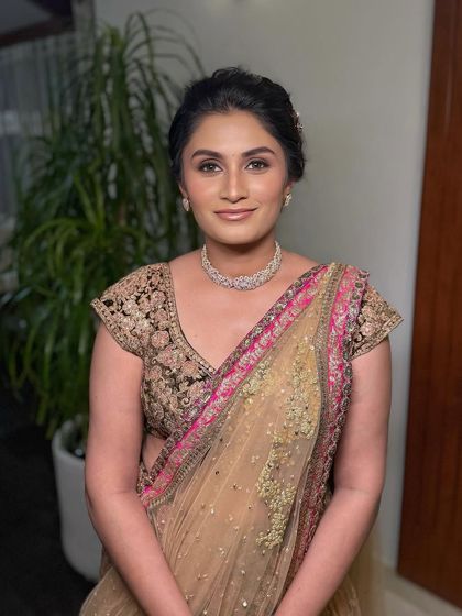 A luminous look for a reception, featuring dewy skin, accentuated eyes, and a Sabyasachi lehenga.