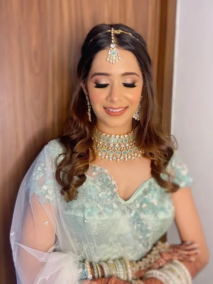 A close-up of Aashna's wedding look, showing the soft pink and champagne tones on her eyes that complement her pastel outfit.
