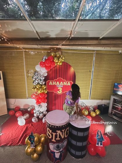 Our founder Gauri putting the finishing touches on the 'Sing' themed decor, showing the hands-on approach we take with every event.