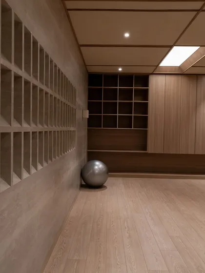 An empty studio space, highlighting the clean lines, gridded wall features, and the soft light from the ceiling.