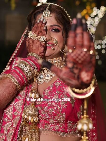 A playful and classic bridal pose. The bride peeks through one eye, hiding the other with her mehendi-adorned hand, creating a fun and memorable shot.