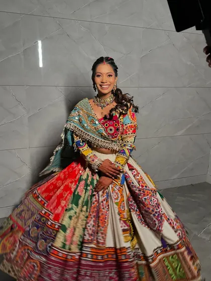 The full splendor of a Navratri outfit. We created a makeup look with a pop of color on the eyes and a fun, braided hairstyle to match the festive vibe.