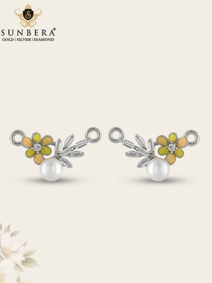 These silver antique mangalsutra pendants combine pearls, sparkling stones, and yellow enamel flowers. They are a perfect example of jewellery that captures the essence of both past and present.