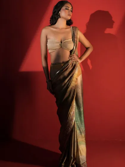 A modern and sensual take on the saree. I styled this printed saree with a strapless bandeau blouse against a bold red backdrop for a high fashion editorial look.