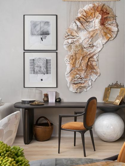 A creative workspace featuring our Koko Desk and Desk Chair. The desk combines a solid oak top with a monolithic Banswara marble support, while the leather-upholstered chair provides comfort and style, creating a haven for productivity.