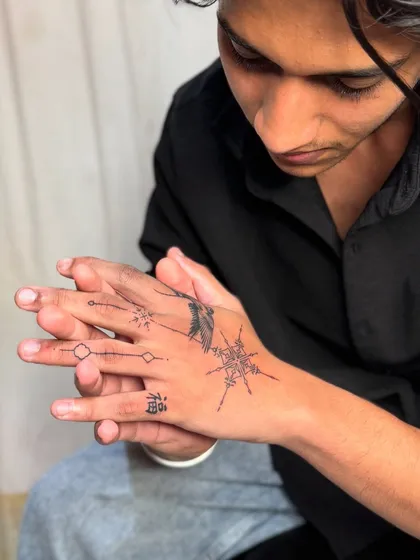 The client admiring his new hand tattoo.