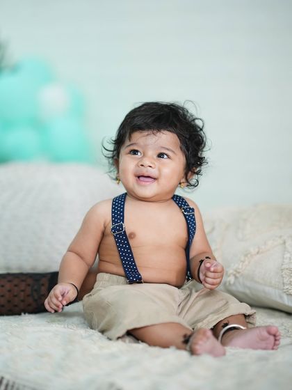 A happy 6-month-old showing off his sitting skills.