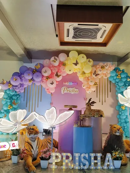 A well-lit photo of the butterfly jungle theme, emphasizing the vibrant colors of the balloons and props.