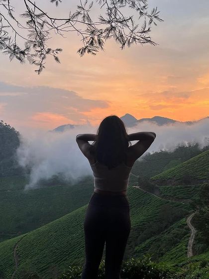 A moment of peace, looking out over the endless green tea plantations of Munnar as the sun sets.