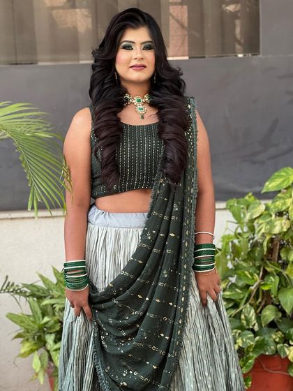 The full look with the voluminous curls, showing how it complements the client's entire outfit.