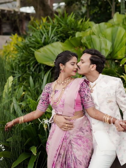 A beautiful portrait of the couple from their engagement shoot, surrounded by lush greenery.