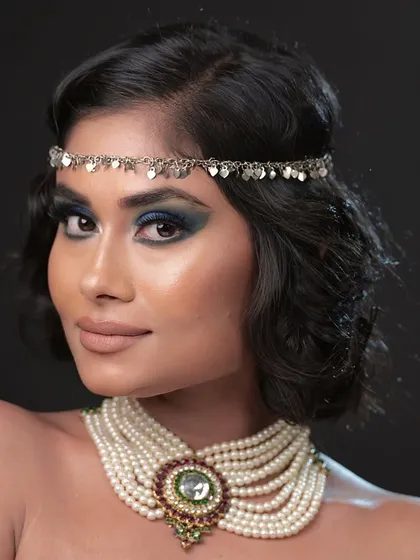 The full look, featuring a pearl choker and a silver headband, giving it a 1920s-inspired feel.