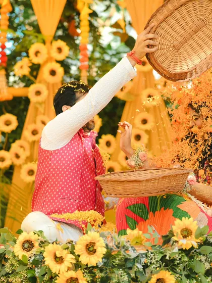 And the groom returns the favor. This action shot captures the playful flower fight during a fun-filled Haldi ceremony.