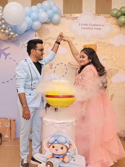 Adventure is in the air! This gender reveal used a vibrant smoke bomb to announce the baby's gender against a whimsical travel-themed backdrop. It’s a dynamic and colorful way to celebrate the journey ahead.