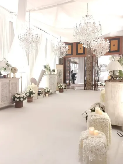 Every part of the guest journey is an opportunity for beauty. I designed this all-white entrance passage with crystal chandeliers and classic furniture to build anticipation and welcome guests into a world of elegance.