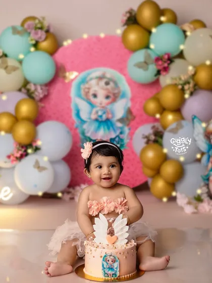 One-derful and covered in cake! This little angel is having a heavenly time with her first birthday cake.