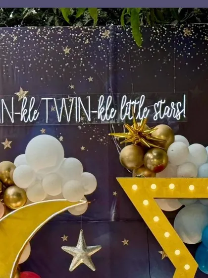 The neon sign "TWIN-kle TWIN-kle little stars!" against the starry night backdrop, serving as a perfect centerpiece for the theme.