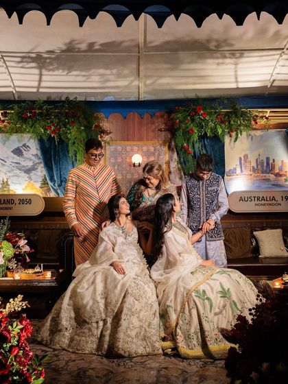 A beautiful family portrait taken within one of the custom-built train lounges. The destination signs in the background represent significant places in the family's journey.