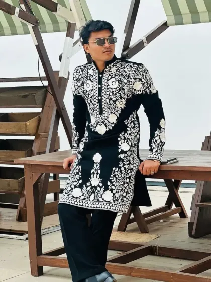 A striking black kurta with all-over white floral embroidery, a bold and fashionable choice.