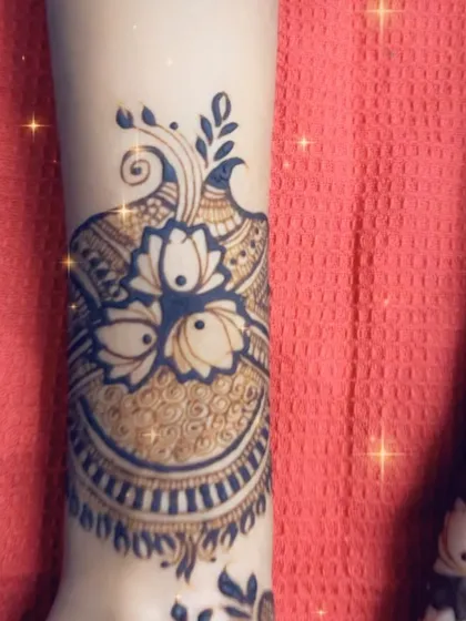 A modern designer mehendi piece with a large lotus motif, perfect for a sangeet or engagement party.