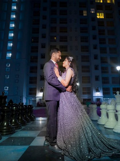 A stunning night-time portrait of a couple on a giant chessboard. This creative and dramatic shot is perfect for a glamorous reception or engagement shoot.