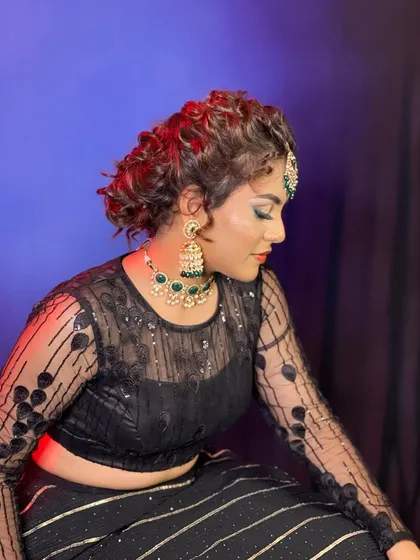 A side profile of the creative Indo-Western look, showing the texture in the hair and the bold makeup.