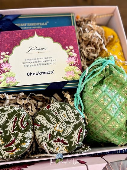 A closer look at a modern Indian gift box. It includes items from Forest Essentials, dry fruits in Kalamkari-print jars, and a sequined potli, all curated to create a rich tapestry of textures and colors.