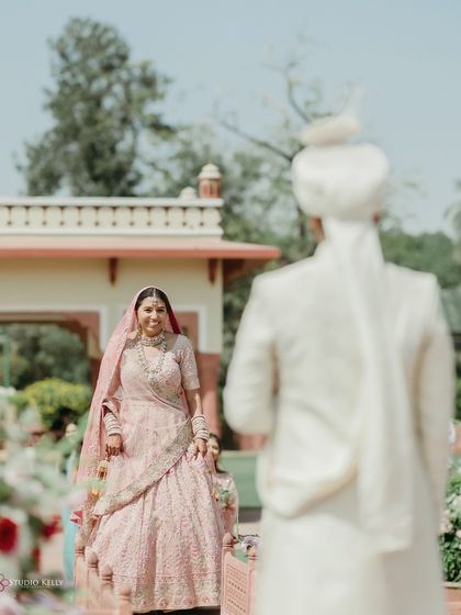 The groom's first look at his bride walking down the aisle at the Jai Mahal Palace in Jaipur. A candid, emotional moment that is the heart of any wedding story.