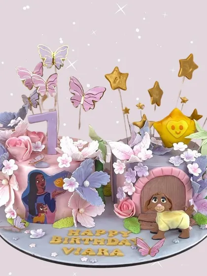 A magical, sparkling cake for Viara's 7th birthday. This creation is adorned with butterflies, stars, and flowers, creating an enchanted forest feel.