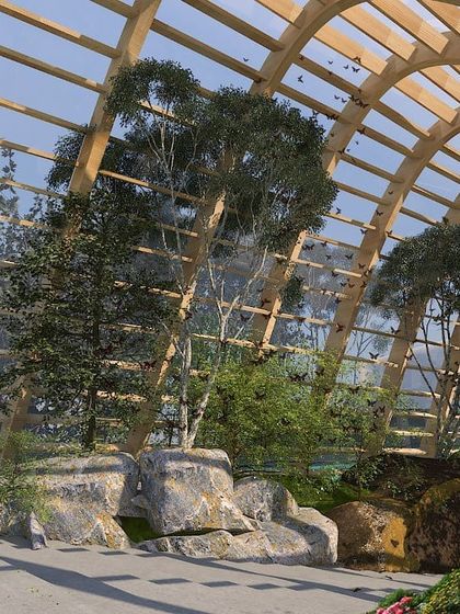 A conceptual design for a public space using clean timber technologies like Glulam. The arched wooden frame creates a greenhouse like structure that can house trees and plants, bringing nature into the urban environment.