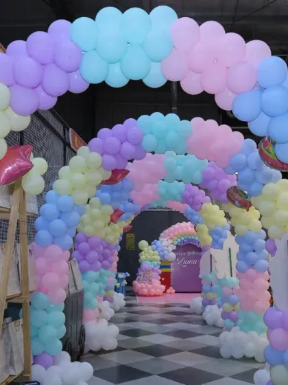 A tunnel of pastel rainbow balloons creates a magical entrance for a princess or unicorn-themed party. We love designing immersive experiences for our guests.