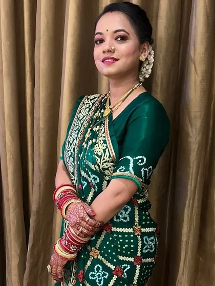 A happy client ready for a wedding event. I gave her a classic makeup look and a traditional hair bun adorned with a fresh gajra to match her beautiful green bandhani saree.