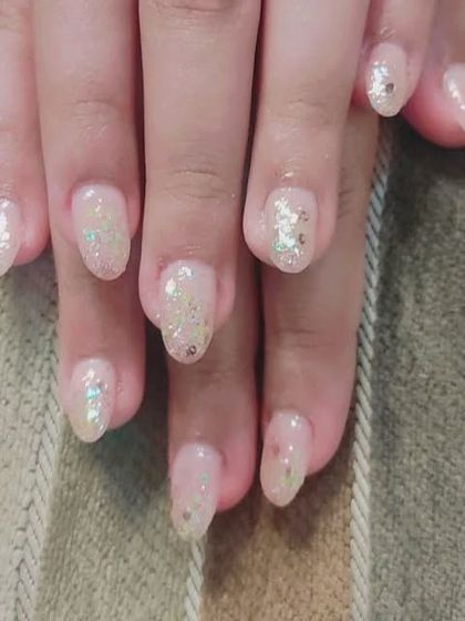 A similar style with a nude pink base and scattered iridescent glitter. This is a great way to have some bling that still feels natural.