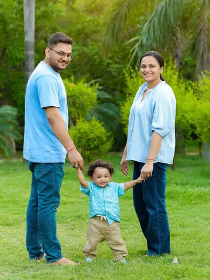 Those first wobbly steps are a huge milestone. An outdoor photoshoot is a great way to capture your toddler's growing independence while you hold their hands for support.
