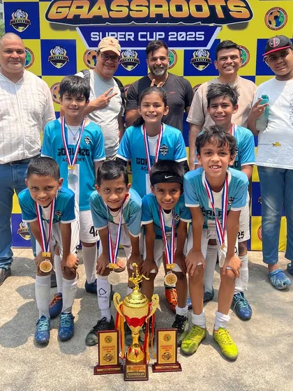Our young champions with their parents and the trophies from the Grassroots Super Cup 2025. A true team effort on and off the field.