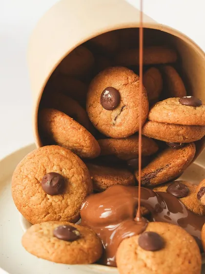 Indulge in the ultimate treat: warm chocolate chip cookies drizzled with rich milk chocolate. This is what happiness looks like.