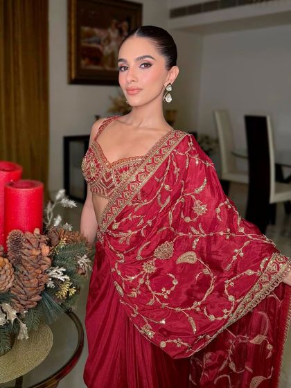 A close-up of the final makeup, featuring a soft smokey eye, flawless skin, and a neutral lip, allowing the stunning red outfit to take center stage.