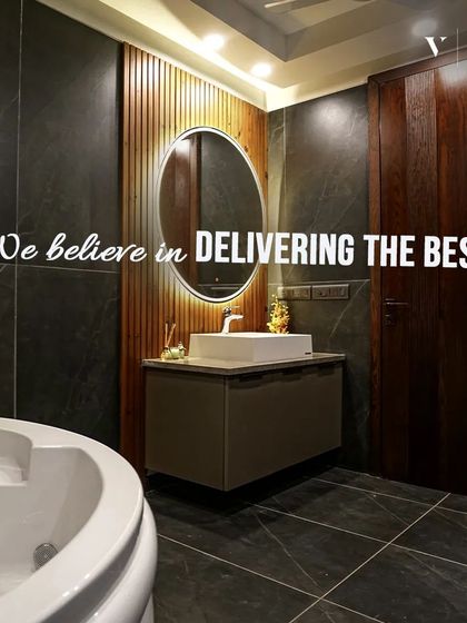 We believe in delivering the best, and this bathroom is a testament to that. The design features a dark, dramatic color palette, a modern jacuzzi tub, and a floating vanity with a backlit mirror.