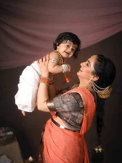 A joyful, uplifting moment between mother and child. The dynamic pose and genuine smiles make this a standout portrait from the festive series.