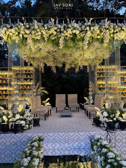 This floral wonderland captures the essence of love in full bloom. I designed this mandap with a canopy of cascading white blossoms and a candlelit backdrop to create a breathtakingly romantic atmosphere.