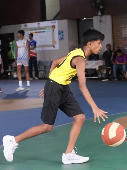 A player dribbles with speed, pushing the ball up the court. This is the fire and journey of becoming a Maniac.