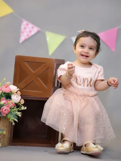 A simple yet beautiful studio portrait for a first birthday. The 'one' bodysuit and sparkly tutu make for a classic and adorable birthday outfit.