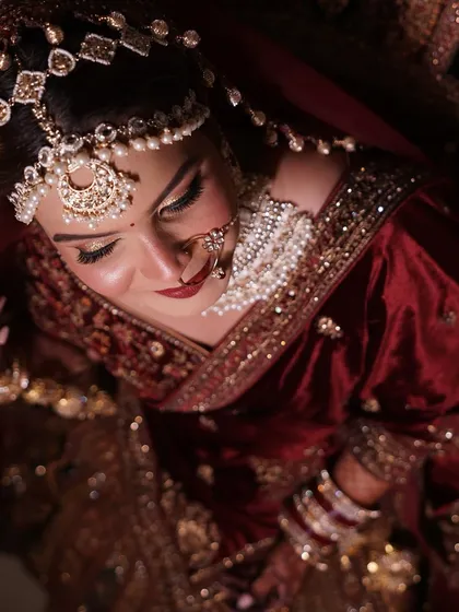 The final look from above. A stunning portrait of my bride in her velvet maroon lehenga, showcasing the rich colors and royal aesthetic.